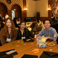 group of student site at table, two women and two men
